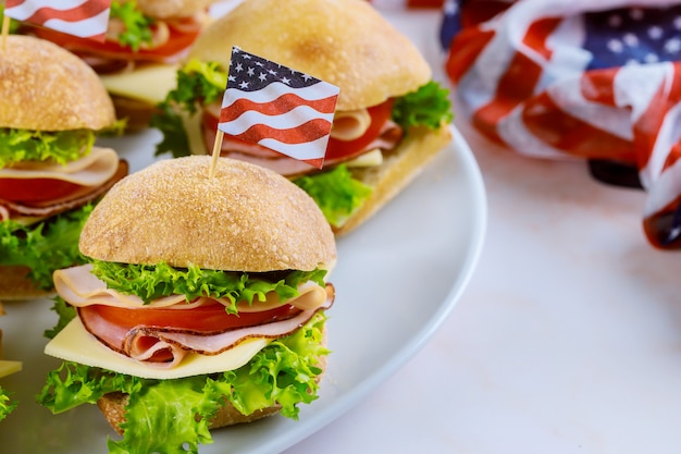 Sandwiches with ham, cheese and tomato for american holiday table.