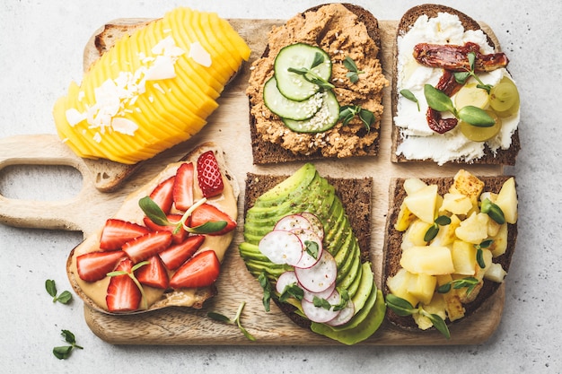 Sandwiches with mango, strawberry, tofu pate, avocado, potatoes and ricotta 