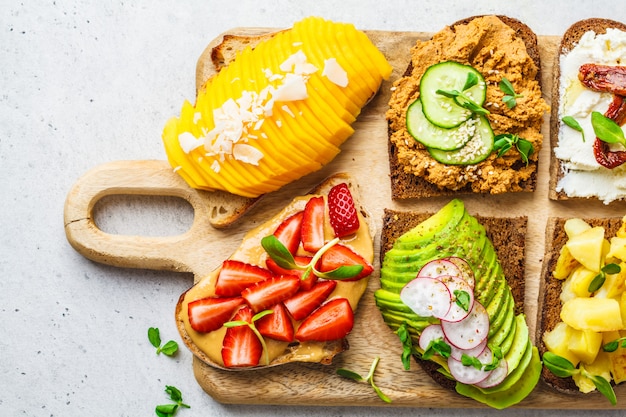 Sandwiches with mango, strawberry, tofu pate, avocado, potatoes and ricotta