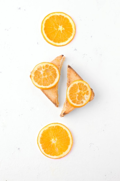 Sandwiches with orange jam on white top view