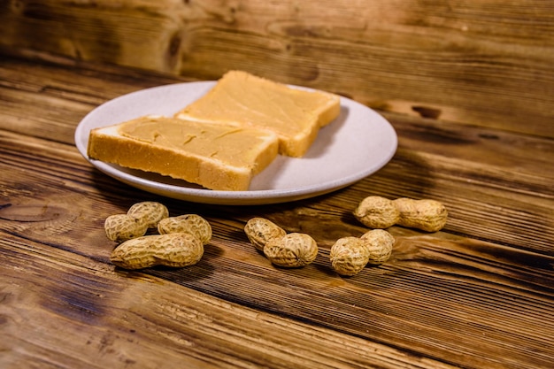 Sandwiches with peanut butter in plate on a wooden table