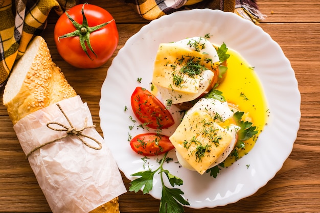 Sandwiches with poached egg, tomato, parsley and cheese. Top view