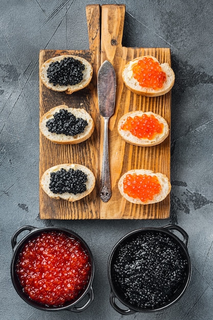 Sandwiches with red and black caviar baguette, on gray