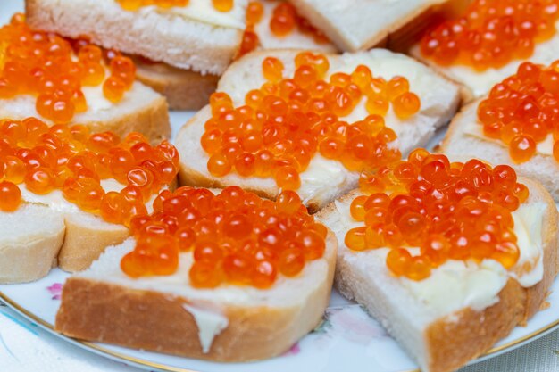 Sandwiches with red caviar and butter close up