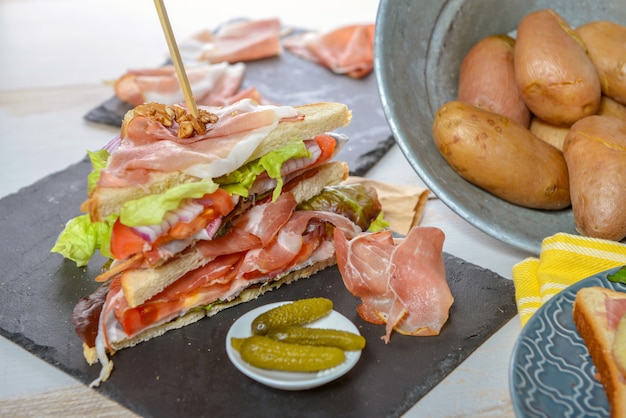 Sandwiches with salad, tomatoes, ham and onions