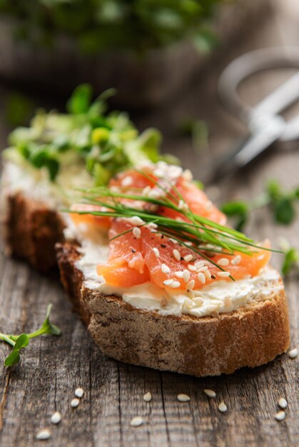 Sandwiches with salted salmon avocado and microgreens