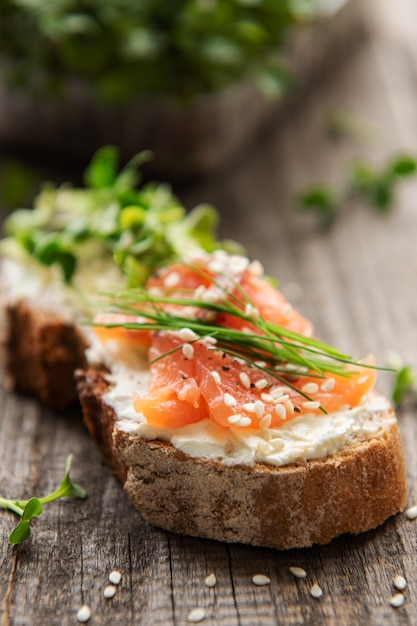 Sandwiches with salted salmon avocado and microgreens