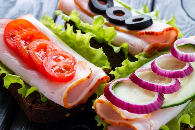 Sandwiches with tomatoes chop olives and red onion