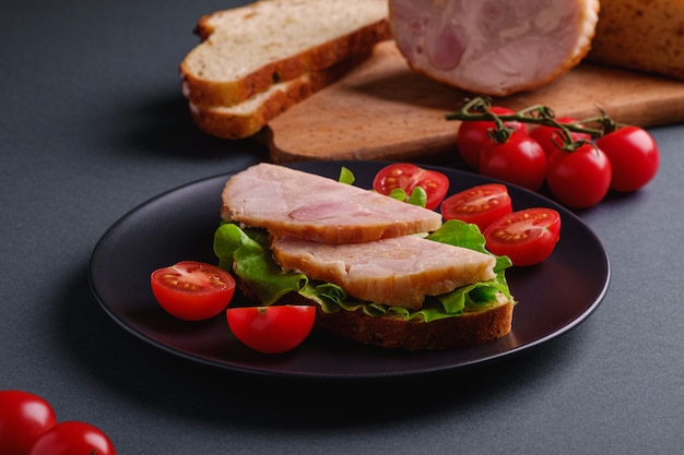 Sandwiches with turkey, green salad and fresh cherry tomatoes