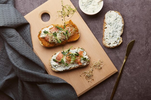 Sandwiches with zucchini and cream cheese spread fish alfalfa sprouted peas greens sour cream garlic sauce Low in calories healthy breakfast superfood