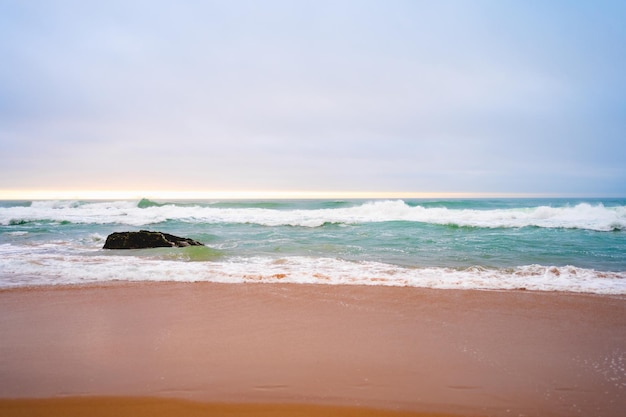 Sandy beach and ocean with turquoise water