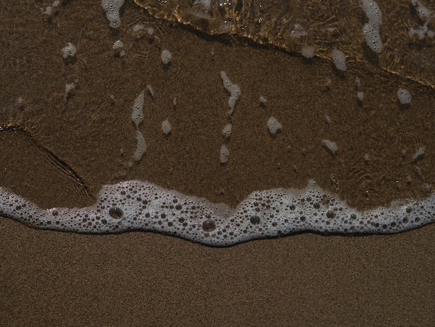 Sandy beach and sea waves