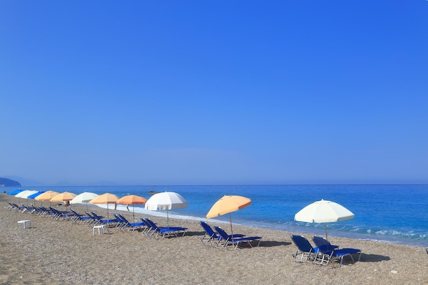 Sandy beach with parasols and sunbeds Gialos Lefkada Greece