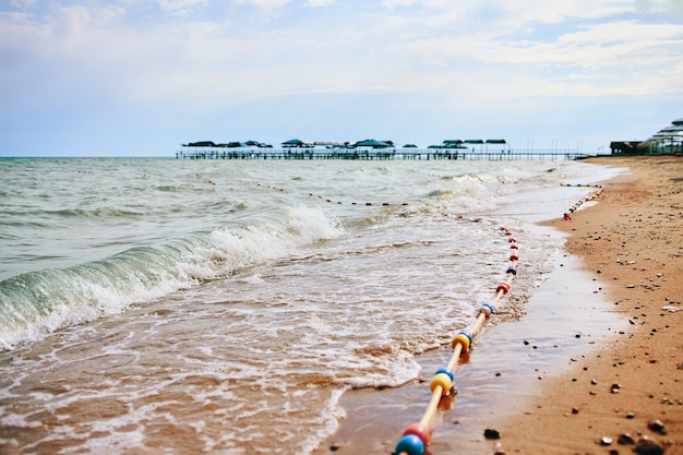 Sandy beach with waves from the sea.