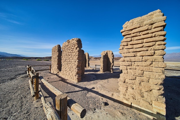 Sandy desert with abandoned and decayed stone structure