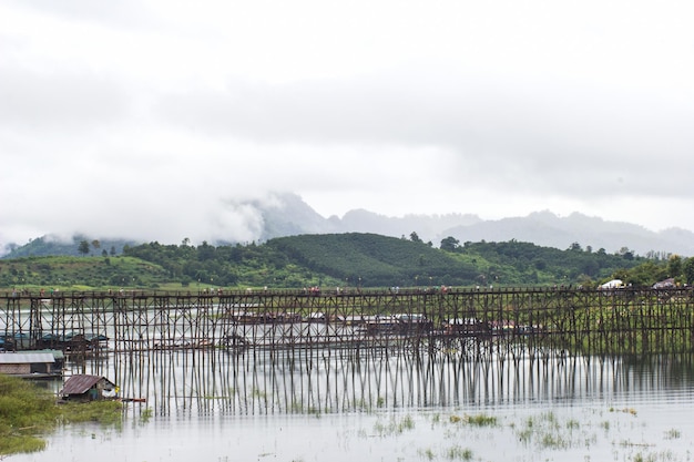 SANGKLABURI KANJANABURI SEP12 2015 Traveler crossing bamboo bridge or Mon Bridge in Sangklaburi Kanchanaburi Thailand Attractions traditional way of life