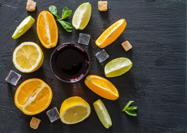 Sangria and ingredients, dark stone background