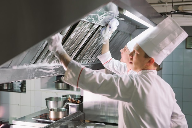 Sanitary day in the restaurant. Repeats wash your workplace. Cooks wash oven, stove and extractor in the Restaurant.