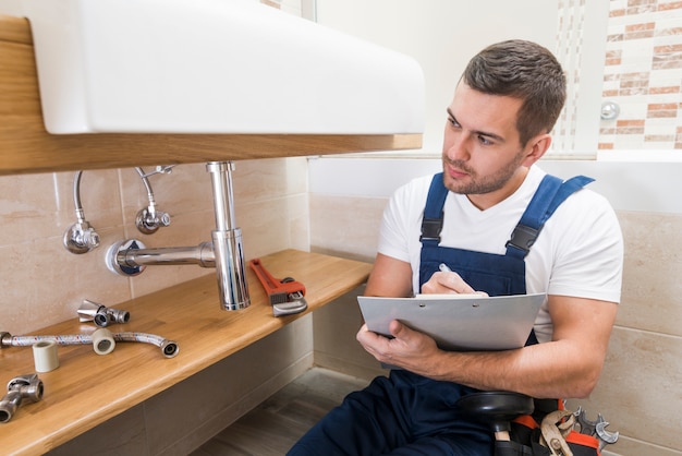 Sanitary technician writing in tablet