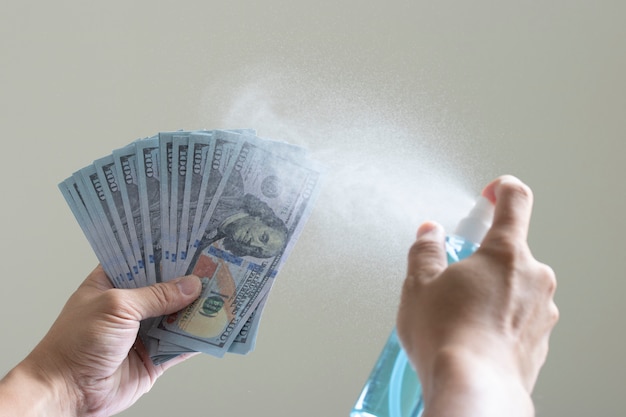 Photo sanitation spray clean bank note contagious disease covid-19 germs money payment
