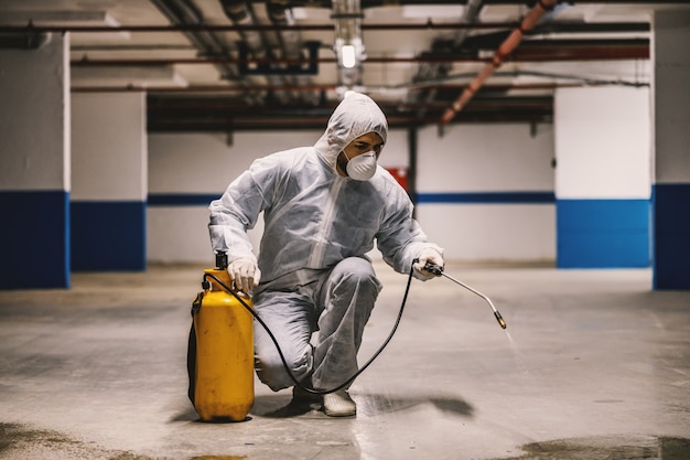 Sanitizing interior surfaces, garage. cleaning and disinfection\
inside buildings, the coronavirus epidemic. professional teams for\
disinfection efforts. infection prevention and control of epidemic.\
p