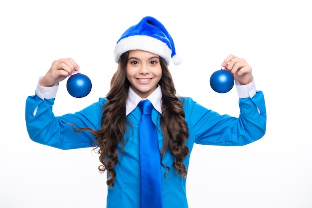 Santa child girl Christmas New Year celebration concept Portrait a teenage girl with blue santa hat shirt and necktie hold christmas ball bauble isolated on white background