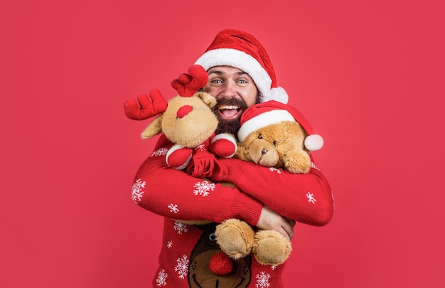 Santa claus bearded man hold toy wish happy new year and merry christmas holiday ready to celebrate winter party with fun and joy full of xmas presents and gifts, shopping mall.