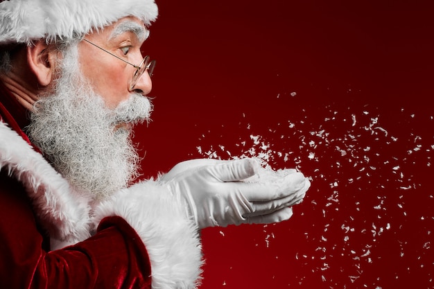 Santa Claus Blowing Snow on Red