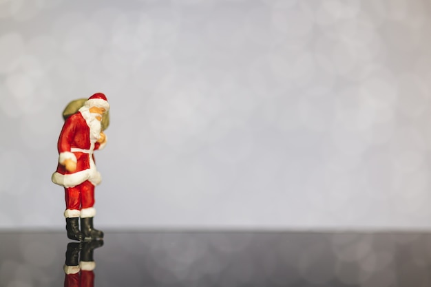 Santa Claus carrying bag  on bokeh  background