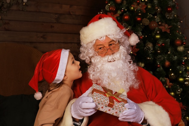 Santa Claus and child at home. Christmas gift. Family holiday concept.