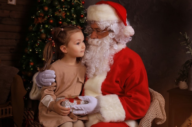 Santa Claus and child at home. Christmas gift. Family holiday concept.