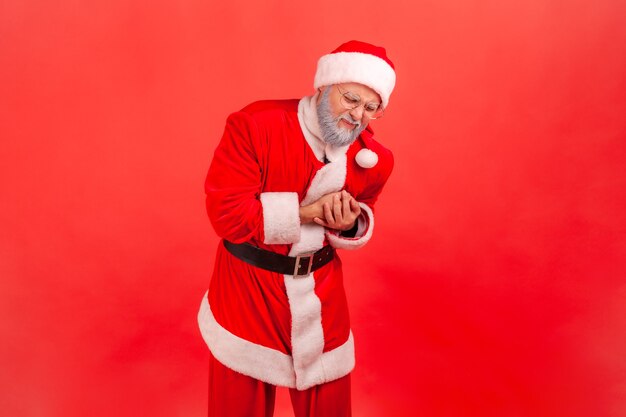 Santa claus clutching breast and grimacing from painful cramp, heart attack at young age