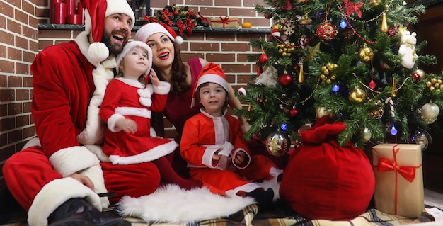 Santa Claus couple with kids Christmas tree