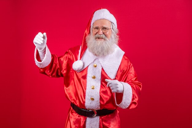 Santa Claus dancing happy on red background