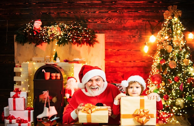 Santa claus father and son with a bag full of presents lovely baby enjoy christmas santa helper