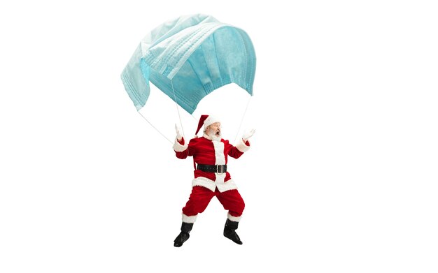 Santa claus flying on huge face mask like on balloon isolated on white background