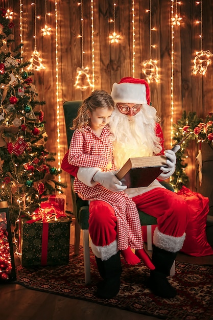 Santa Claus giving a present to a little cute girl