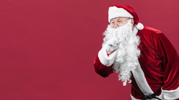 Santa Claus in glasses showing secret gesture 