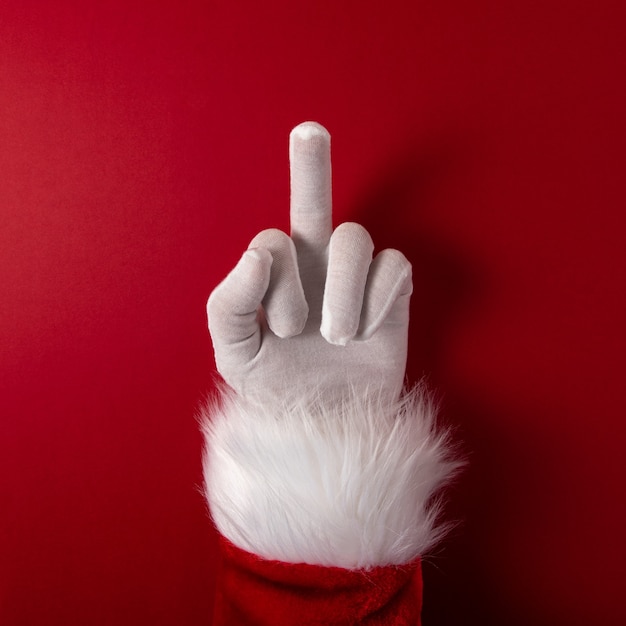 Santa Claus gloved hand is showing middle finger