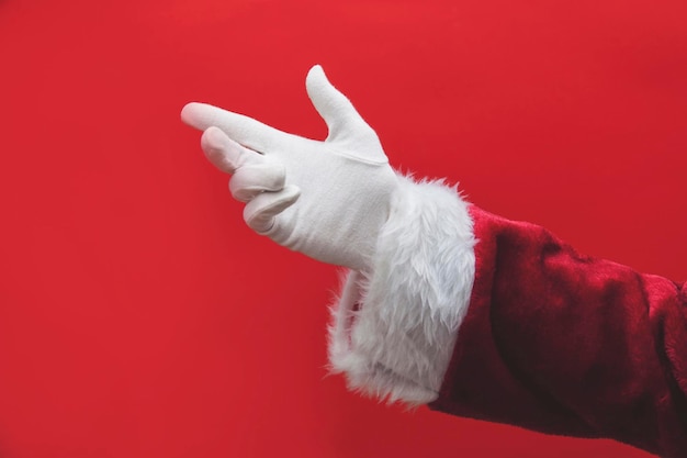 Santa Claus hand against a red background