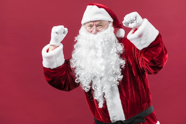 Santa Claus in hat showing fists