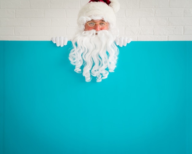 Santa Claus holding banner blank. Merry Christmas greeting card