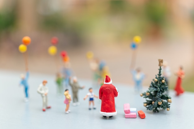 Santa Claus holding gift for happy family