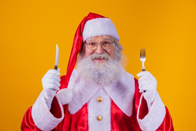 Санта-Клаус держит нож и вилку