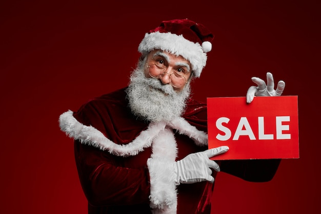 Santa Claus Holding Sale Sign