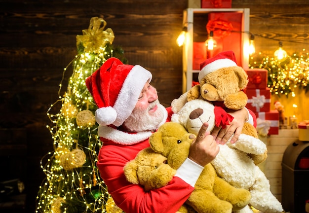 Santa claus holds teddy bear christmas decoration merry christmas christmas holidays happy new year