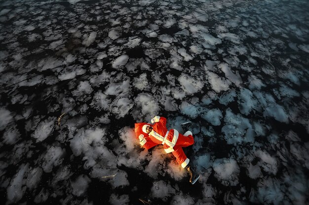 Santa Claus hurries to meet the New Year with gifts and Christmas tree. Santa Claus on ice skates goes to Christmas.