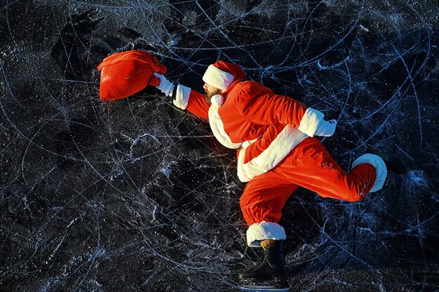 Santa Claus hurries to meet the New Year with gifts and Christmas tree. Santa Claus on ice skates goes to Christmas.