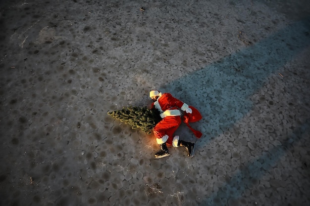 Santa Claus hurries to meet the New Year with gifts and Christmas tree. Santa Claus on ice skates goes to Christmas.