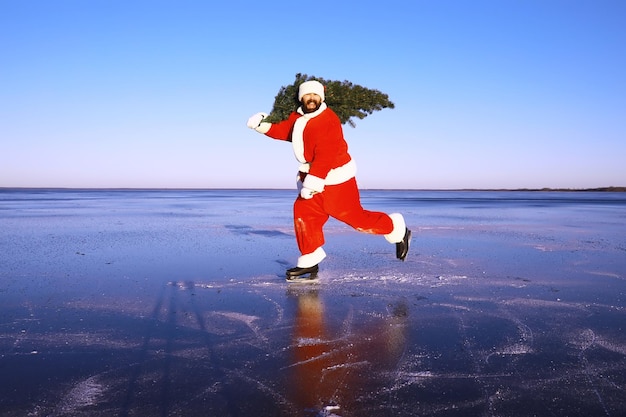 Santa Claus on ice skates goes to Christmas Santa Claus hurries to meet the New Year with gifts and Christmas tree